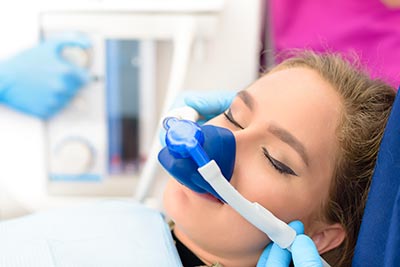 woman asleep during a dental procedure thanks to sedation