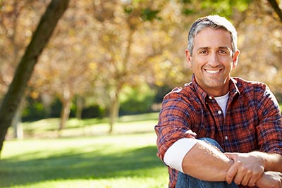 man smiling after dental crowns restored his smile