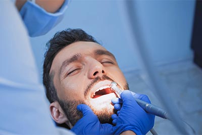 man asleep during dental procedure due to sedation