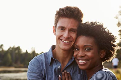 man smiling with his wife after getting Six Month Smiles in Marysville, WA